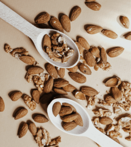 Almonds laying separate on table and on two spoons